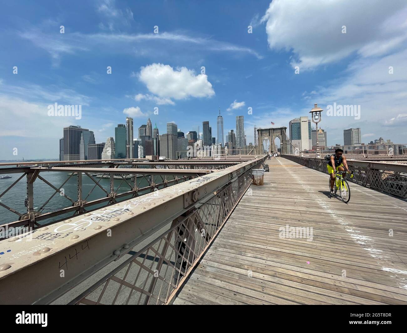 The walkway across the Brooklyn Bridge in New York city has separate lanes for pedestrian walkers and bicyclists. Stock Photo