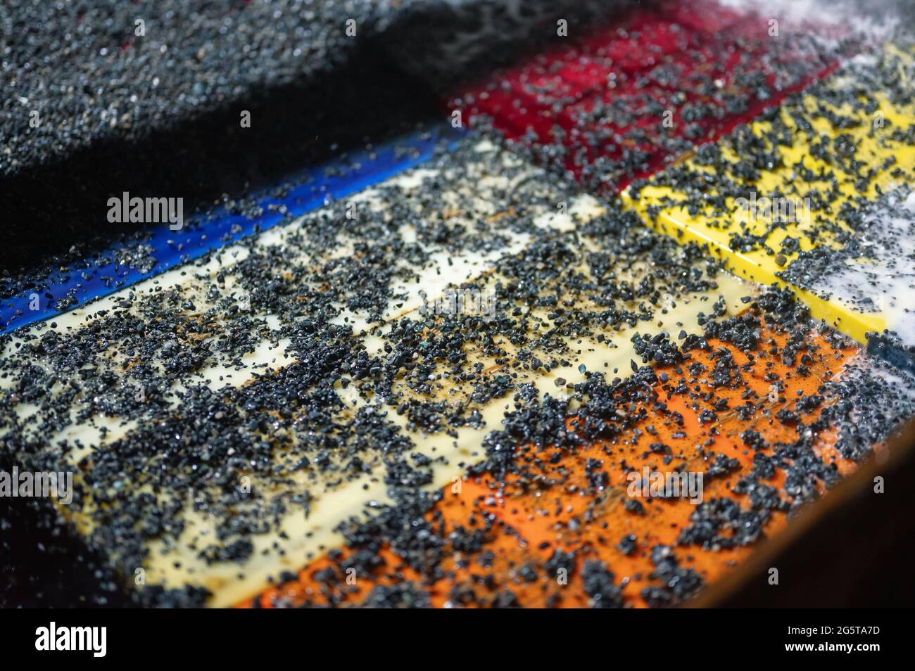 Vibrating screen, ore screening. Lots of small stones on the surface of the sieve Stock Photo