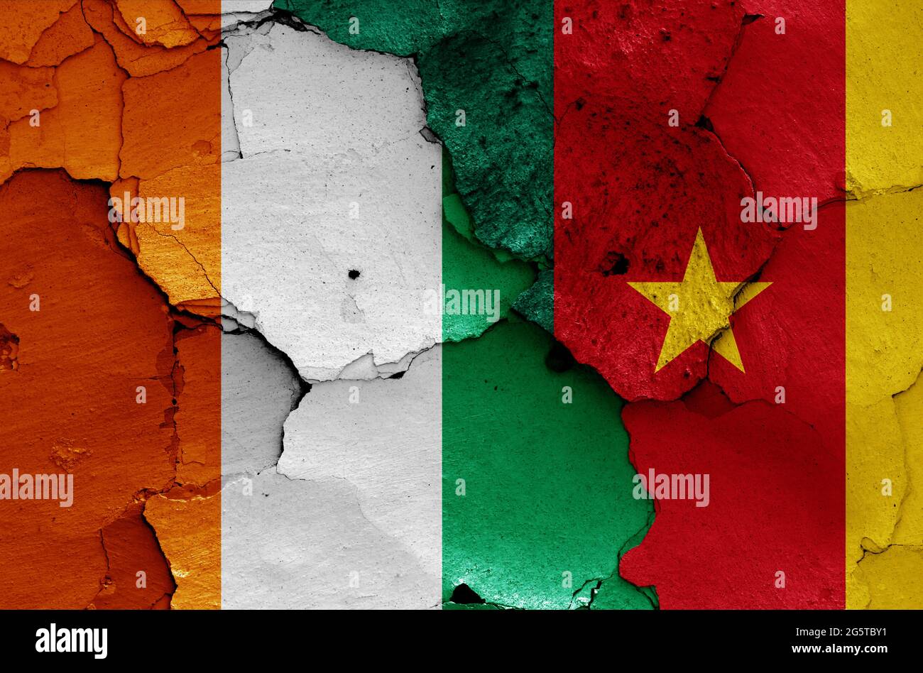 flags of Ivory Coast and Cameroon painted on cracked wall Stock Photo