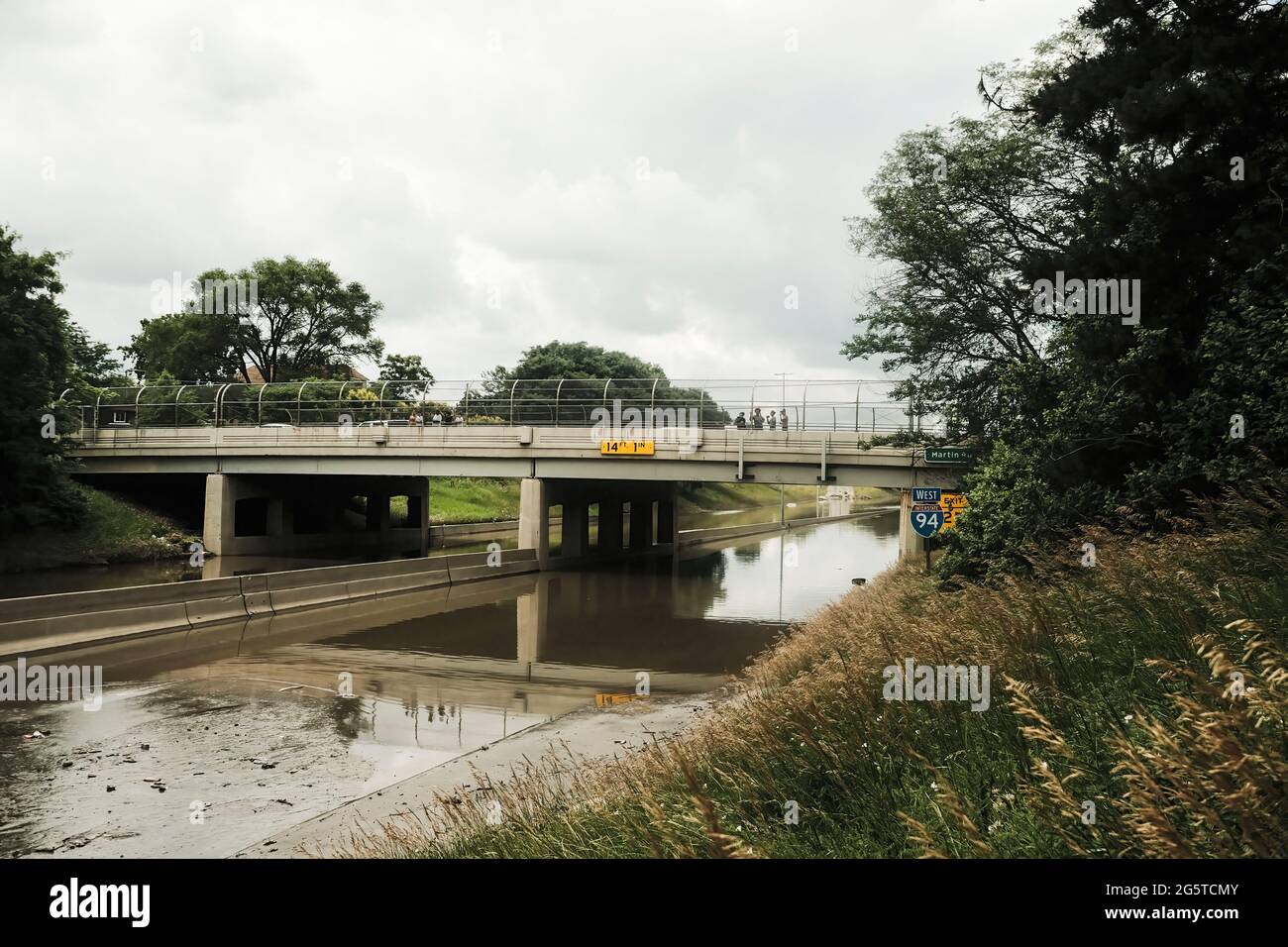 A portion of I-94 remains under several feet of water following a weekend of heavy rain that flooded parts of Metro Detroit and forced some motorists to abandon their vehicles on the interstate. After a weekend of heavy storms beginning on Friday night and lasting through the weekend rainwater flooded parts of I-94 in Detroit, Michigan forcing some motorists to abandon their vehicles and seek shelter from the heavy rains. Flood waters remained in areas along I-94 between Dearborn and Downtown Detroit several days later as Michigan Governor Gretchen Whitmer held a press conference on the still Stock Photo