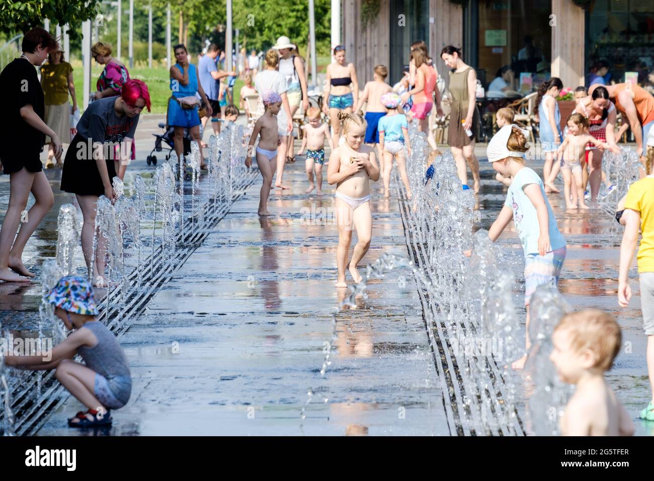 Moscow, Russia, June 26, 2021. Children bathe in the jets of a fountain in the Muzeon Park. Water entertainment for the townspeople on a hot summer Stock Photo