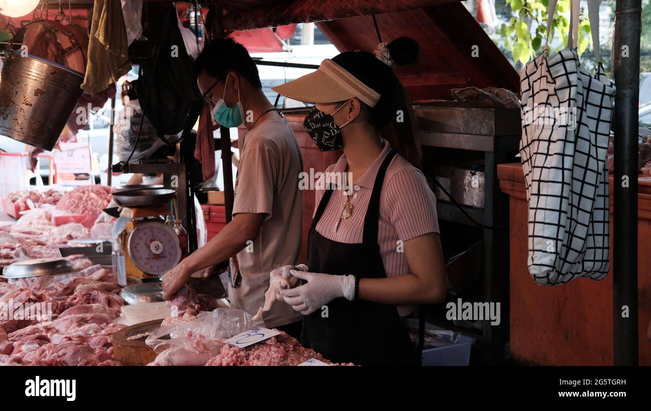 Meat for Sale Young Lady Butcher Klong Toey Market Wholesale Wet Market Bangkok Thailand largest food distribution center in Southeast Asia Stock Photo