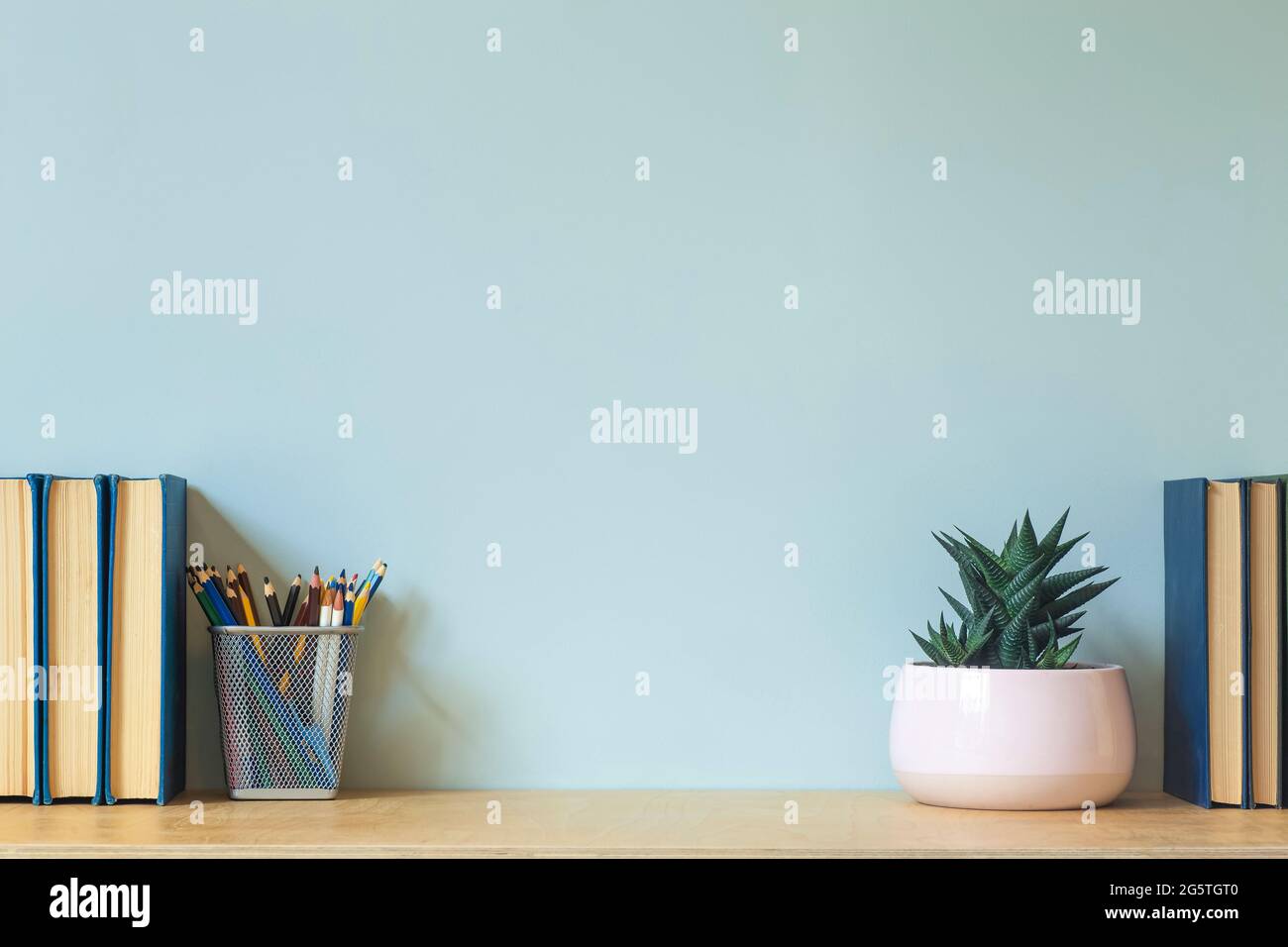 Home office desk table background. Empty wall with wooden table with