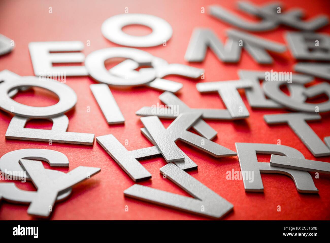 Mixed solid letters pile close up view photo. Education concept on red ...