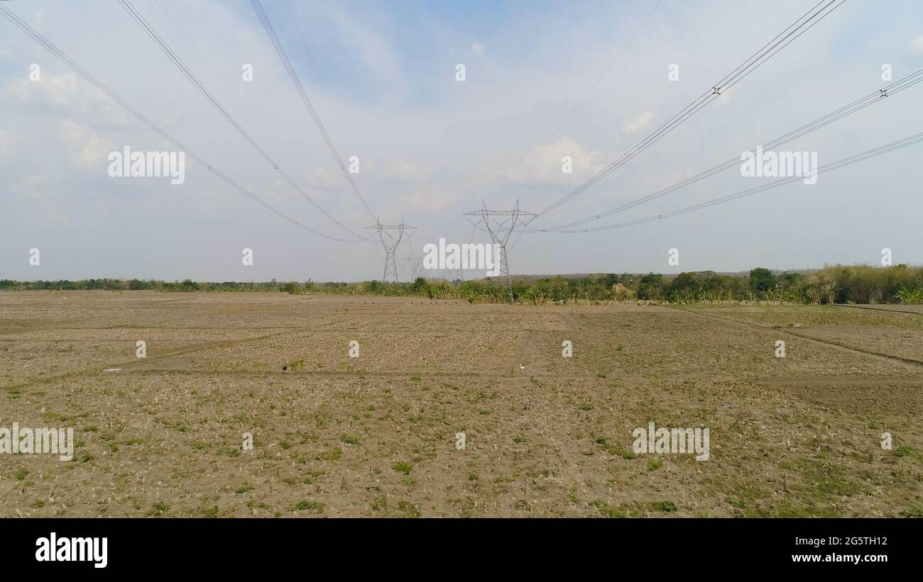 Electricity pylons bearing power supply across rural landscape. aerial ...