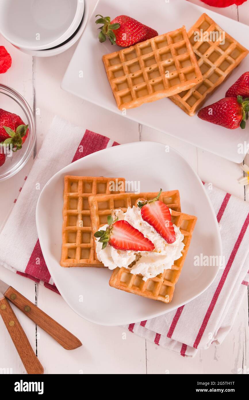 Waffles with strawberries and whipped cream Stock Photo - Alamy