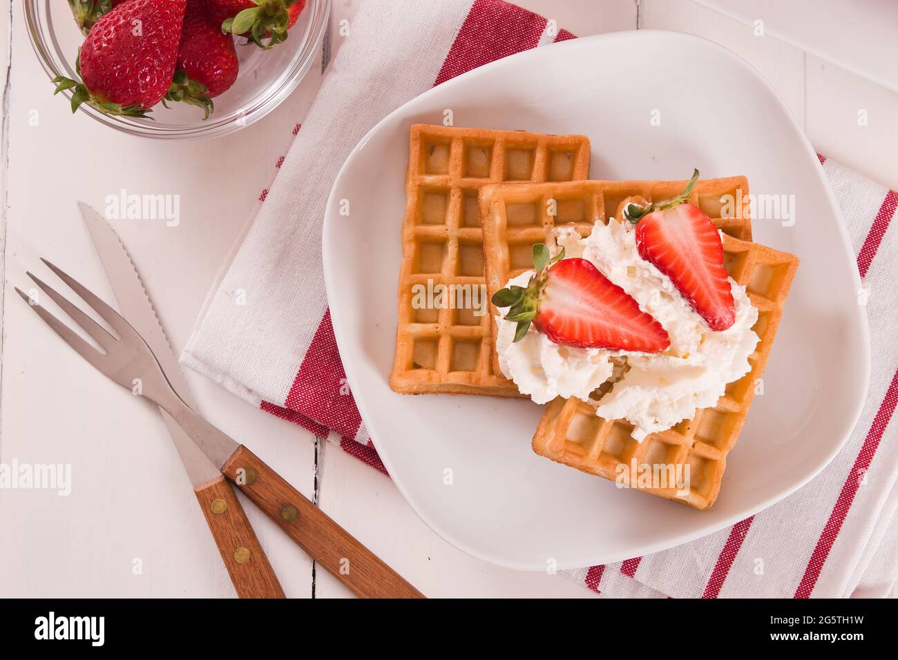 Waffles with strawberries and whipped cream Stock Photo - Alamy
