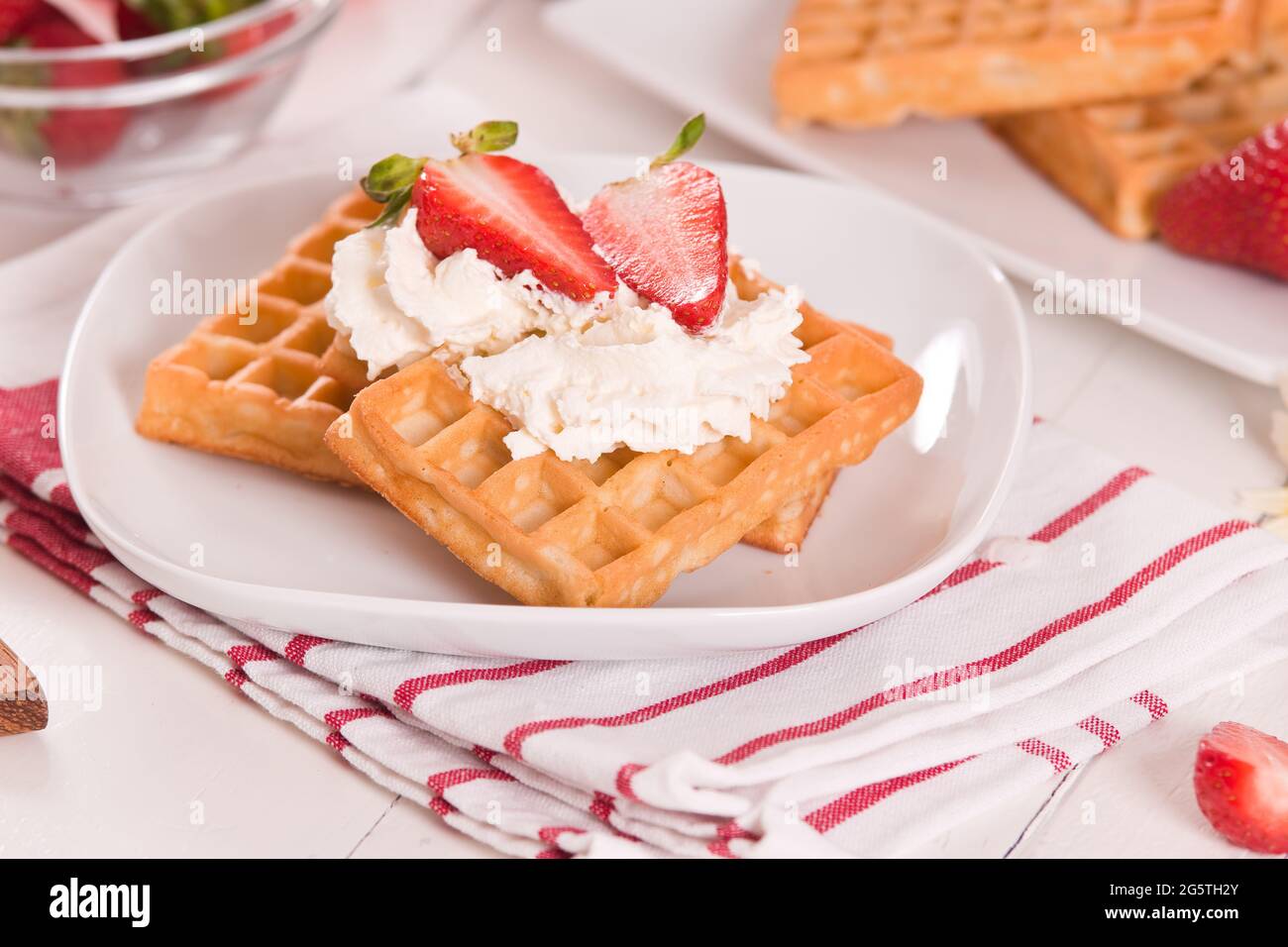 Waffles with strawberries and whipped cream Stock Photo - Alamy