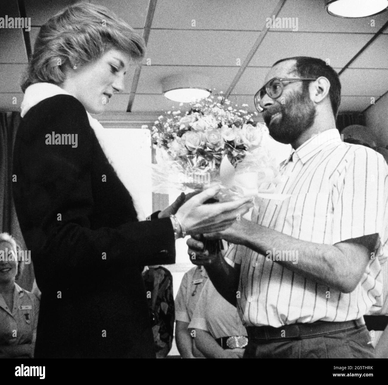 File photo dated 24/02/89 of Diana, Princess of Wales being presented with a bouquet by AIDS patient Martin Johnson during her visit to the Mildmay Mission Hospital AIDS Hospice in East London. The Duke of Cambridge and the Duke of Sussex are preparing to honour their mother Diana, Princess of Wales by unveiling a statue on Thursday on what would have been her 60th birthday. Issue date: Wednesday June 30, 2021. Stock Photo