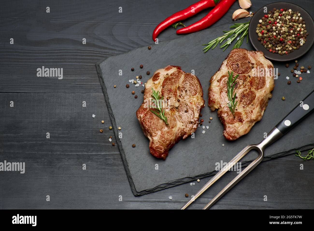 Grilled roated beef steaks on stone serving cutting board Stock Photo ...