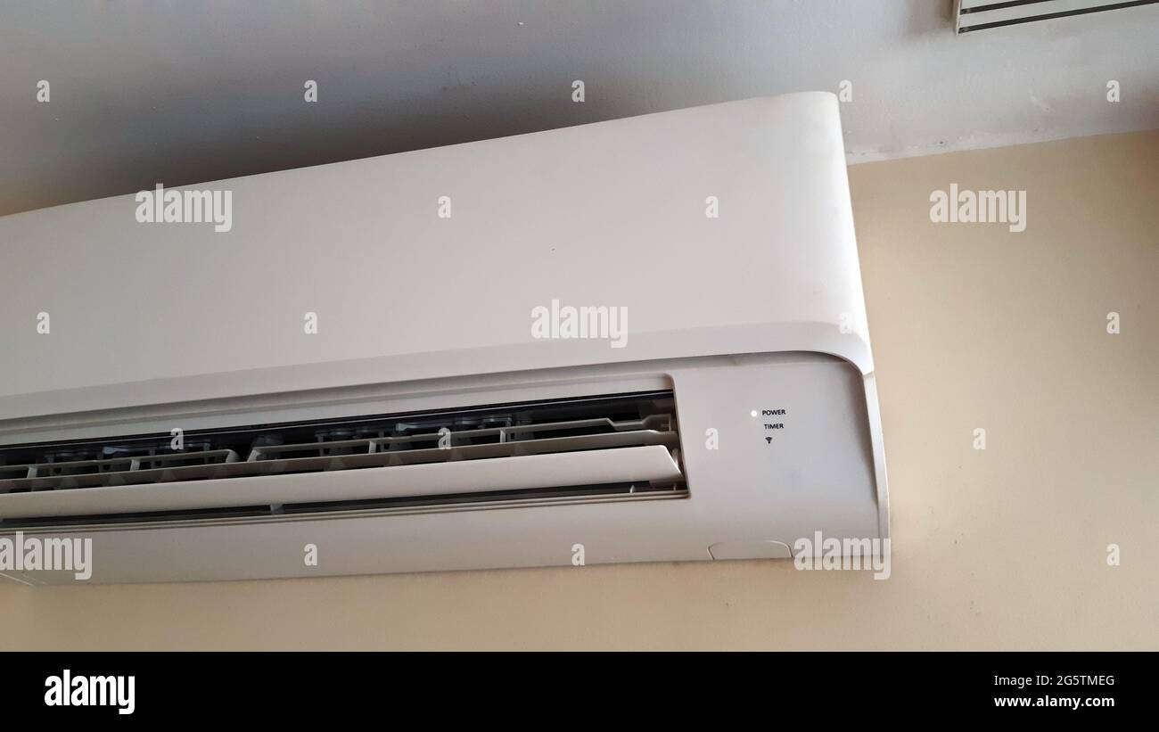 Air conditioner split hanging on the wall. Cooling device in the office room Stock Photo