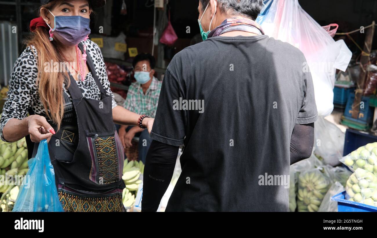 Buyer and Seller Wealth Changing Hands Klong Toey Market Wholesale Wet Market Bangkok Thailand largest food distribution center in Southeast Asia Stock Photo