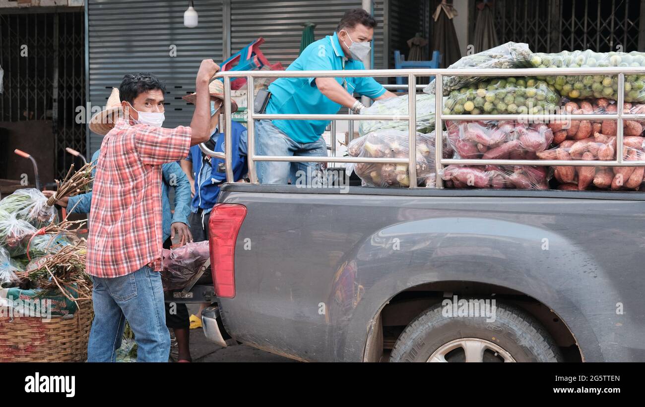 Men Loading Truck Klong Toey Market Wholesale Wet Market Bangkok Thailand largest food distribution center in Southeast Asia Stock Photo