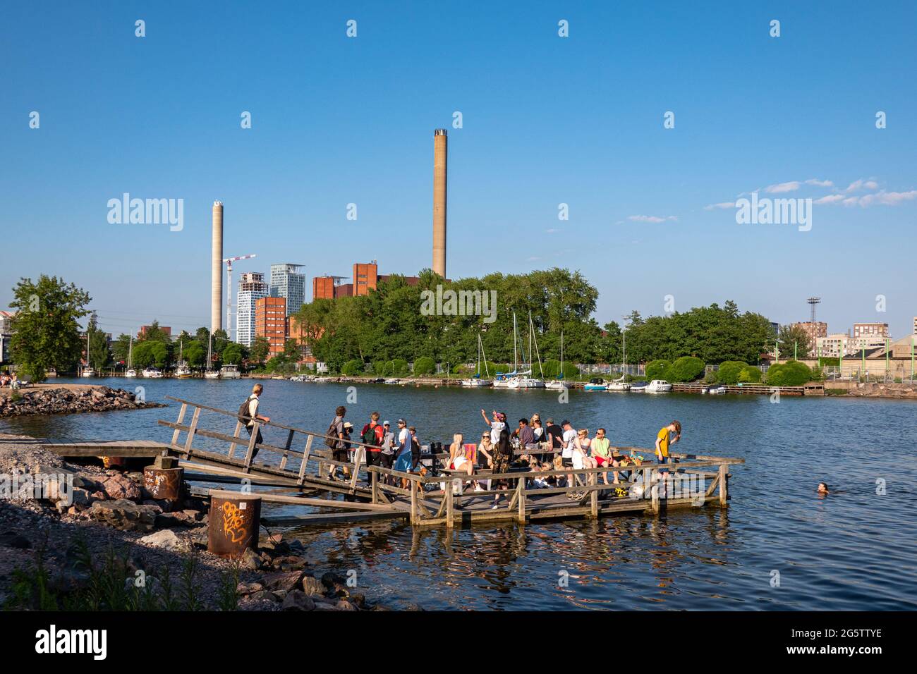 People drinking, celebrating and swimming at Merihaka pier on Saturday evening in Helsinki, Finland Stock Photo