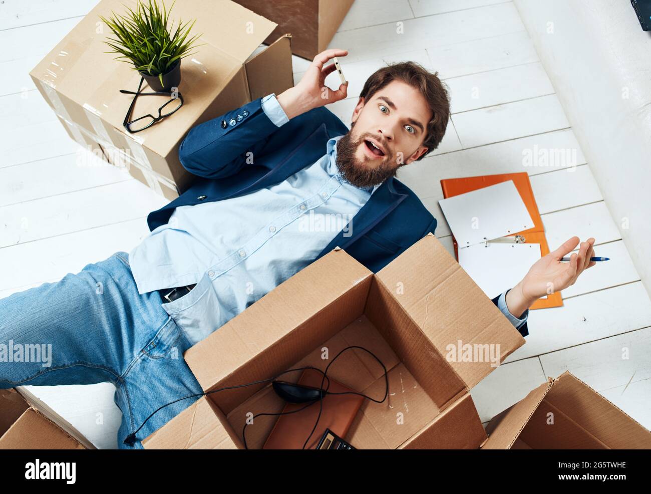 male manager unpacking boxes new job official Stock Photo - Alamy