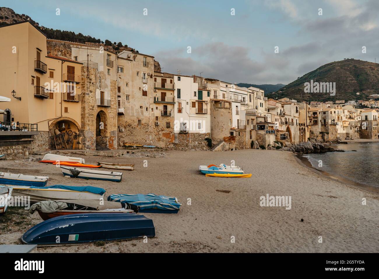 Beautiful old harbor with wooden fishing boats,colorful waterfront stone houses and sandy beach in Cefalu, Sicily, Italy.Attractive summer cityscape, Stock Photo