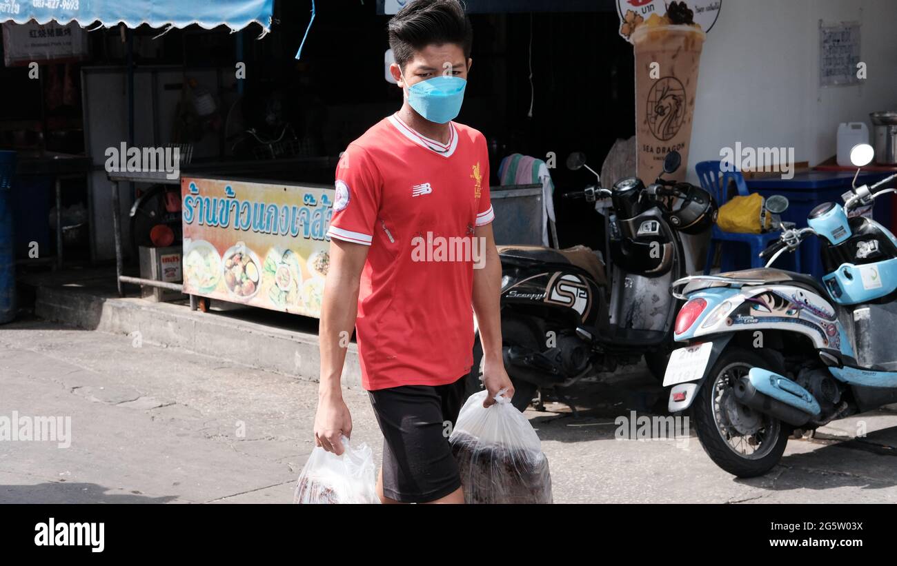 buyer walking with plasticcity bag Klong Toey Market Wholesale Wet Market Bangkok Thailand largest food distribution center in Southeast Asia Stock Photo