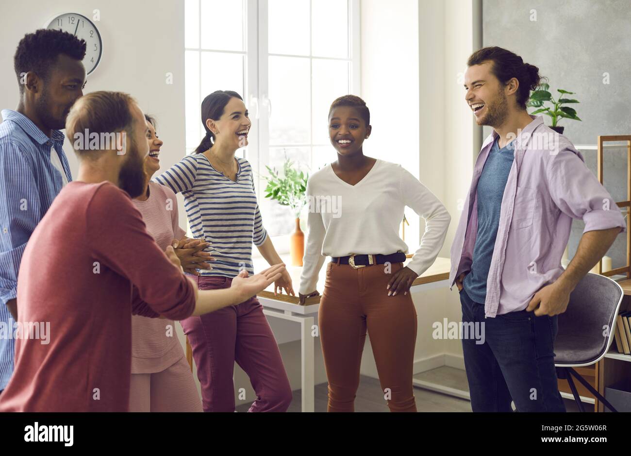 Diverse group of friends telling funny stories, laughing and having fun together Stock Photo