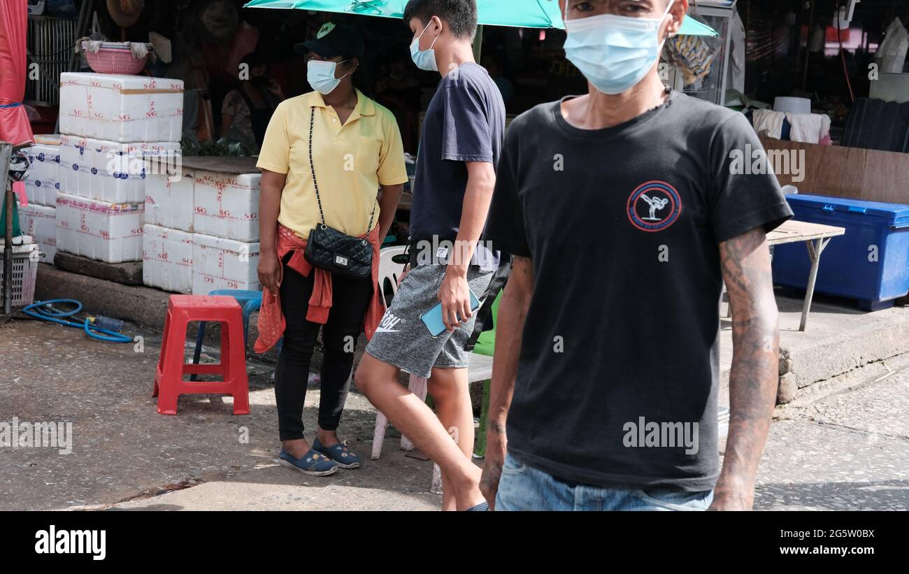 Three Workers Wearing Mask Klong Toey Market Wholesale Wet Market Bangkok Thailand largest food distribution center in Southeast Asia Stock Photo