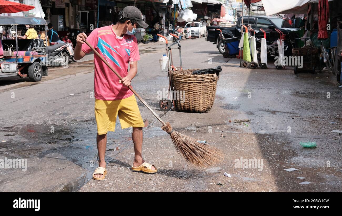Klong Toey Market Wholesale Wet Market Bangkok Thailand largest food distribution center in Southeast Asia street sweeper doing sanitation chores Stock Photo