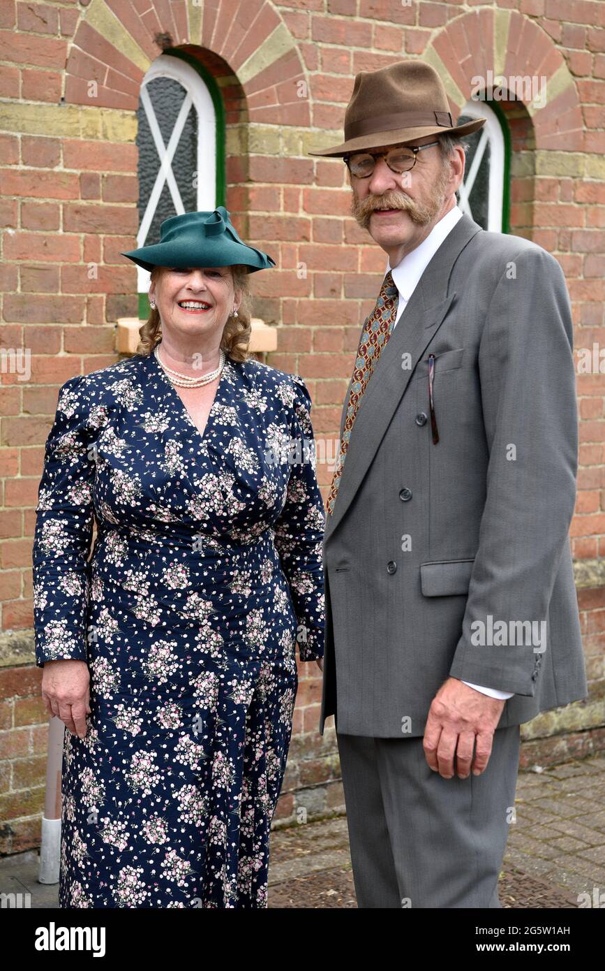 Couple in 1940s costume during the annual War on the Line event at Alresford train station, Alresford, Hants, 13 June 2021. Stock Photo