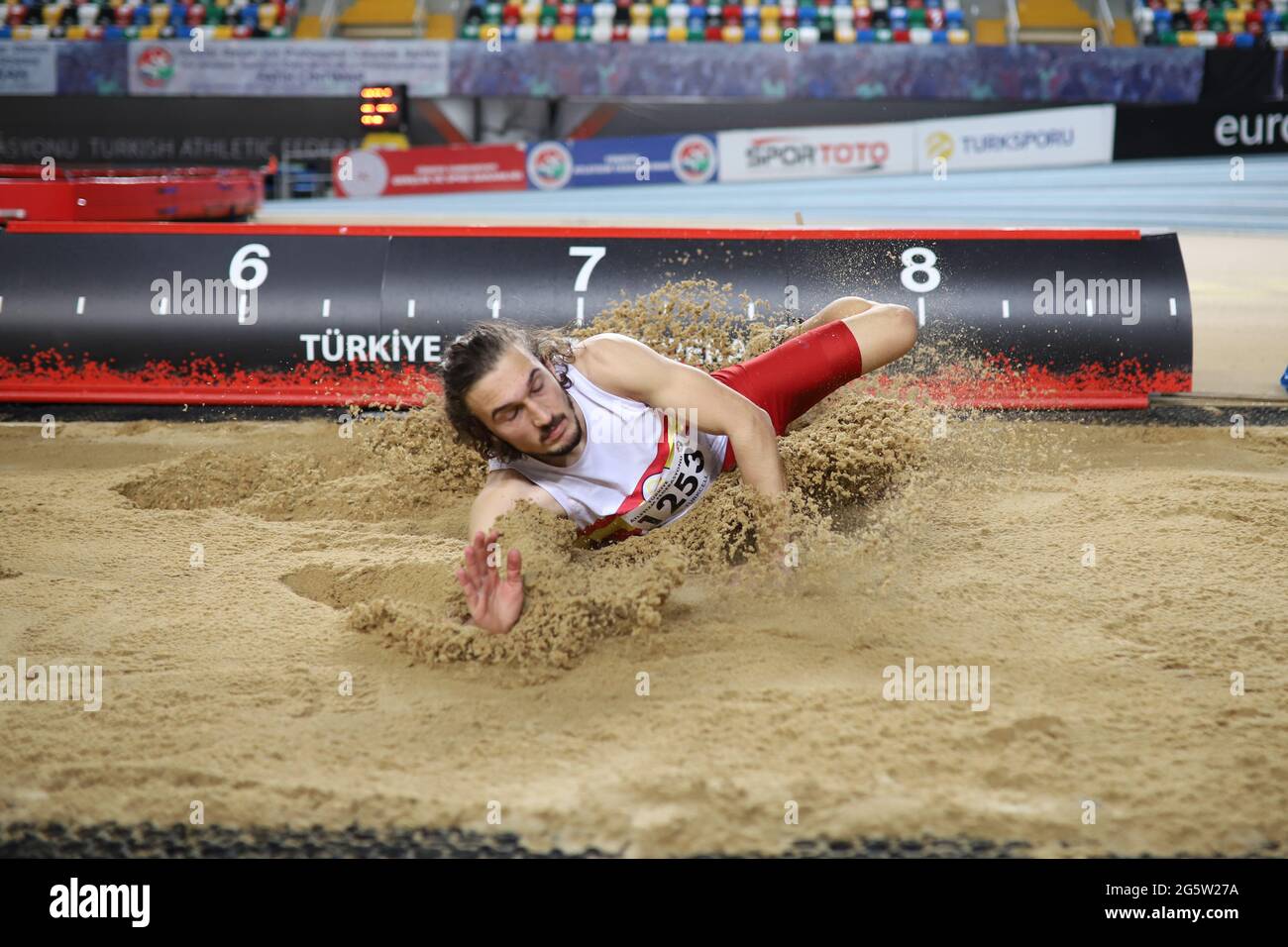 ISTANBUL, TURKEY - MARCH 06, 2021: Undefined athlete long jumping ...