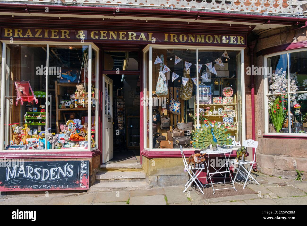 A gift shop has kept the old sign from the former ironmonger's shop which is now Marsden's Gifts in Wirksworth, Derbyshire Stock Photo