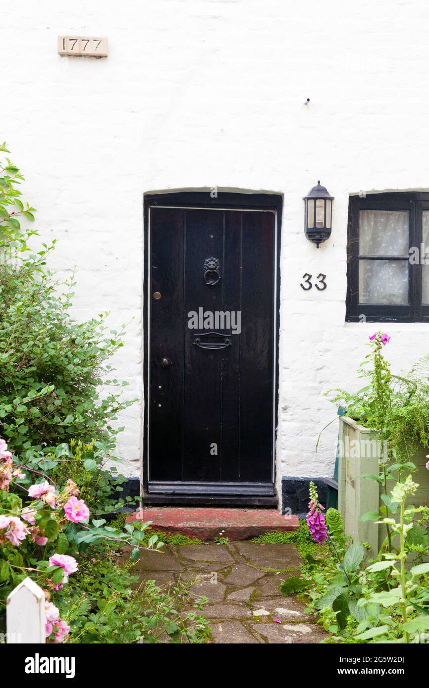 Cottage (built 1777) front door and garden, UK. Stock Photo