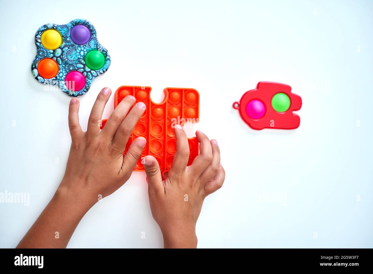 A child with a colorful pop it game. Anti stress. A close up shot