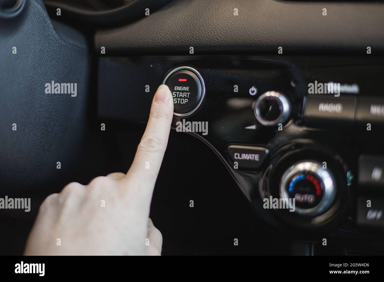Male driver controls the settings of his car with buttons Stock Photo ...