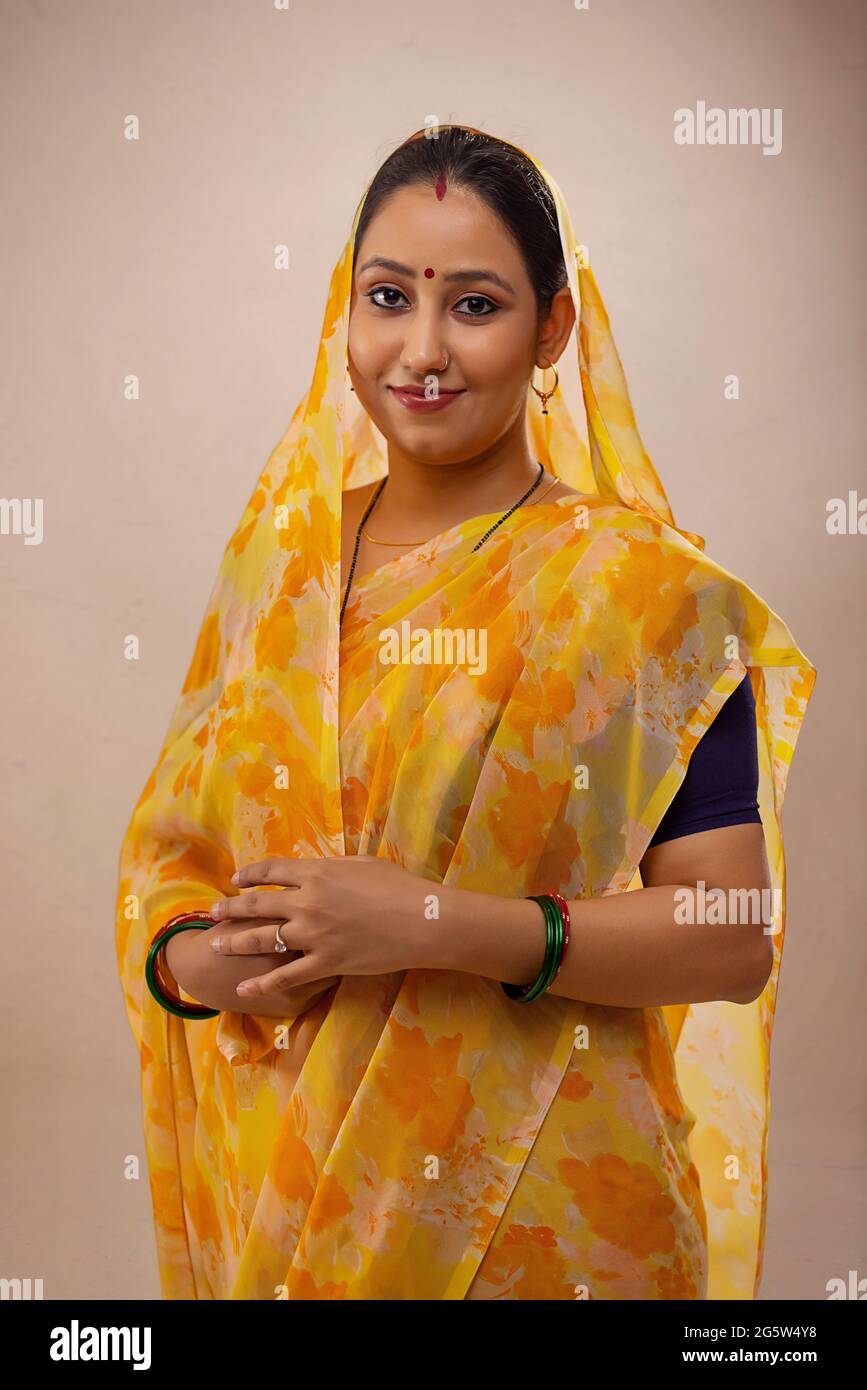Woman wearing yellow saree hi-res stock photography and images - Alamy