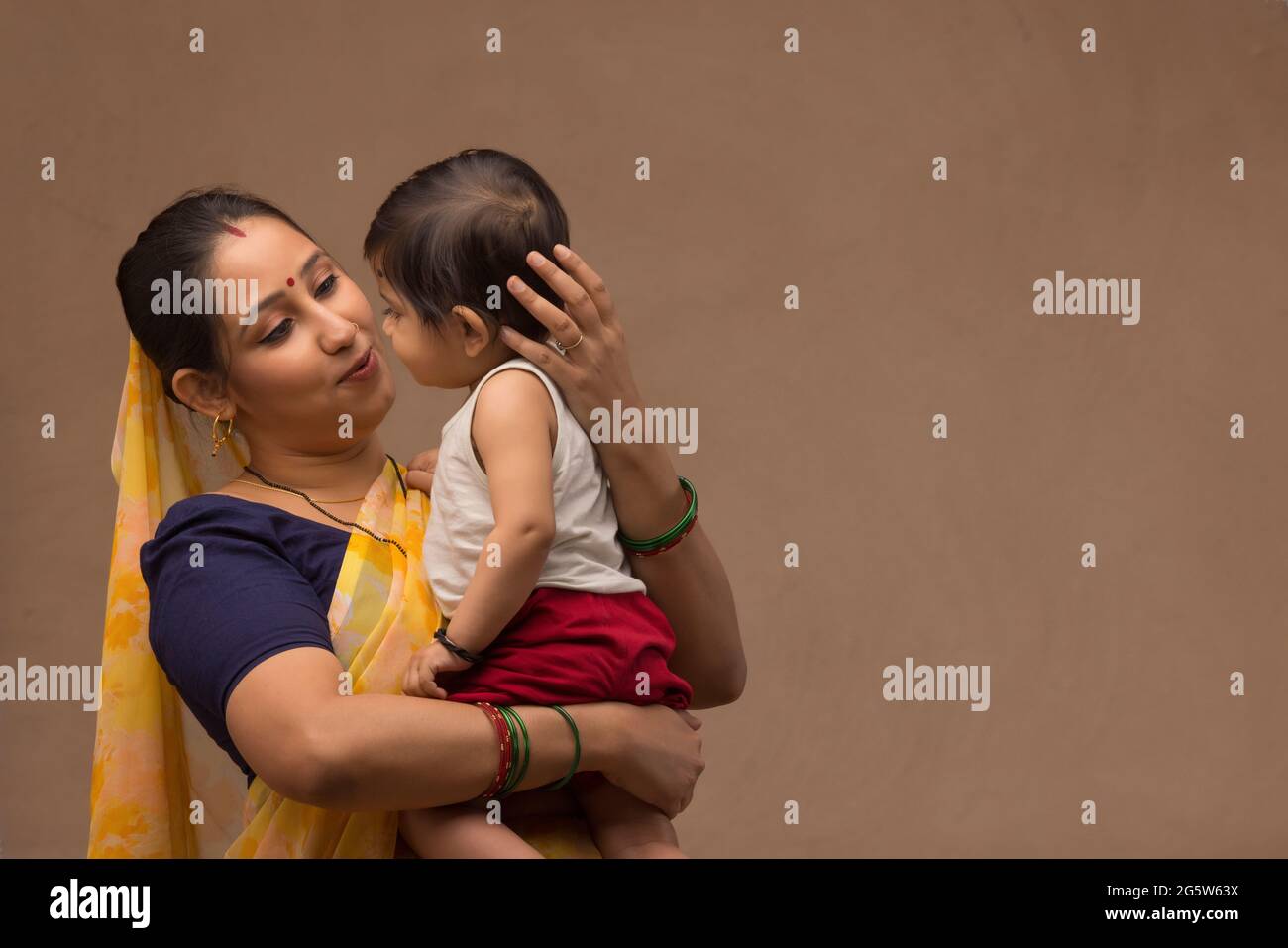 Baby mother holding arms indian hi-res stock photography and images - Alamy