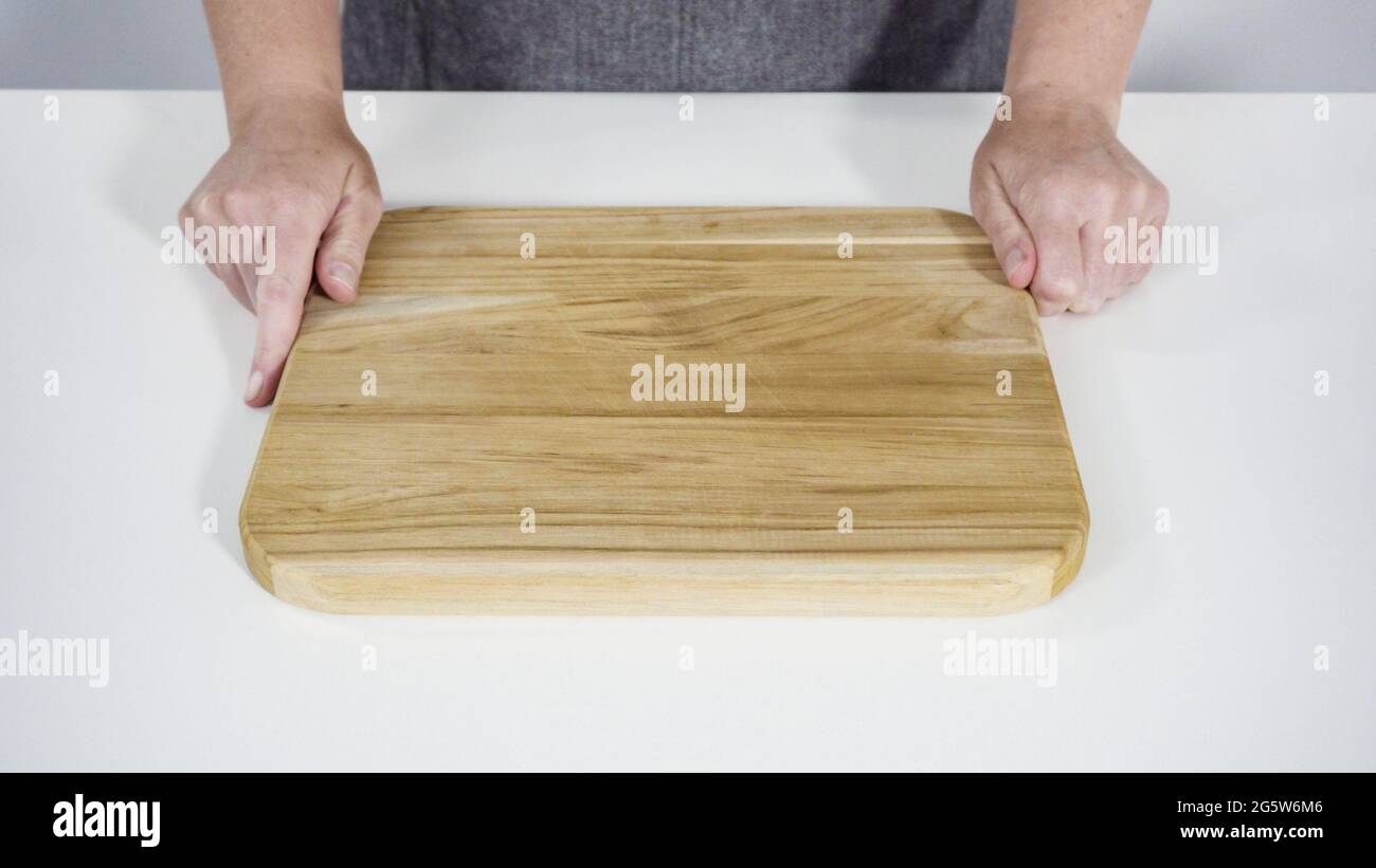 Step by step. Empty wooden cutting board with a kitchen knife Stock
