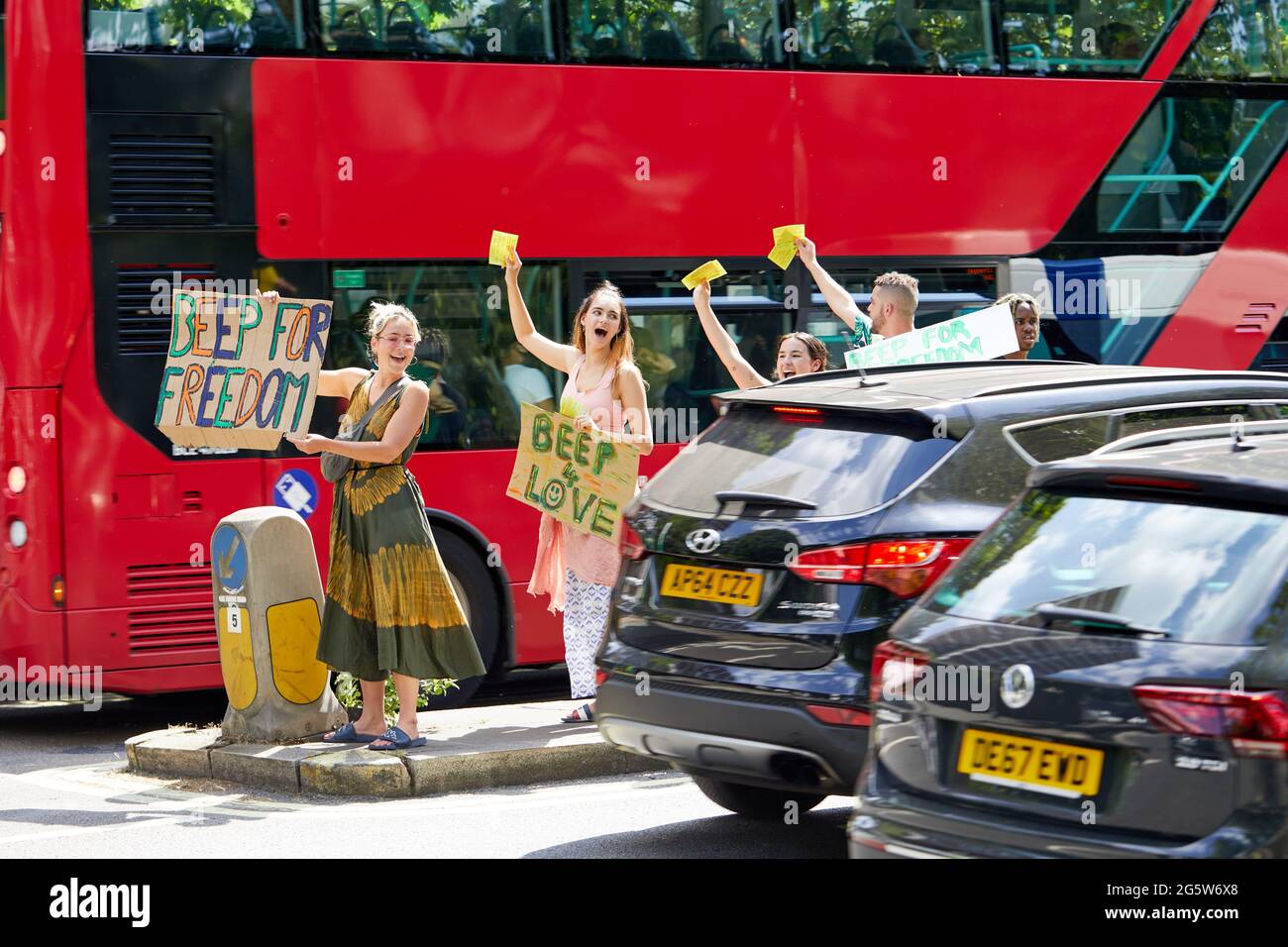 London, UK - 15 June 2021: Protestors from the lovedown anti-lockdown camp on Shepherds Bush Green gain support for their cause from passing motorists. Stock Photo