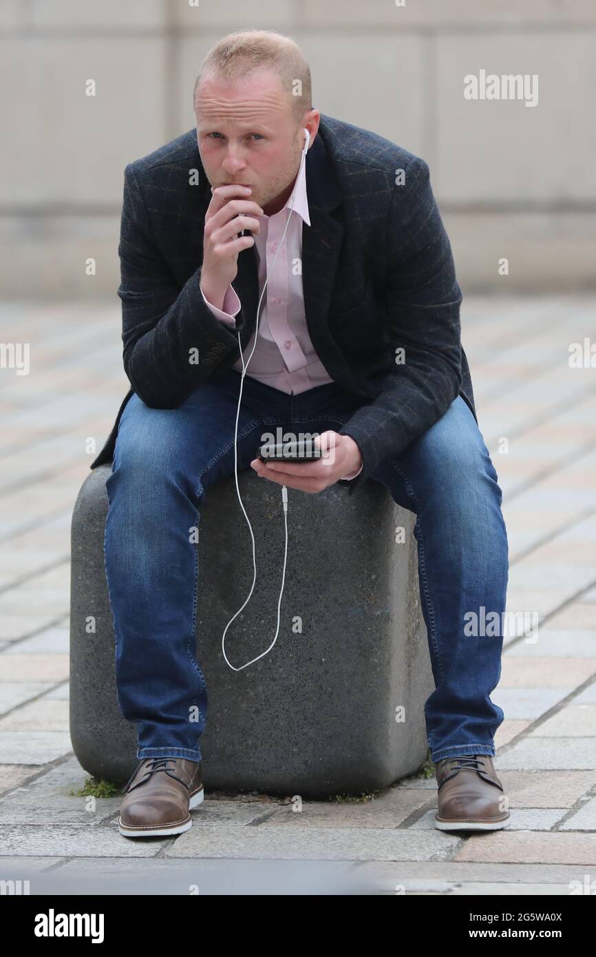Campaigner Jamie Bryson outside Belfast High Court after a judge has rejected all grounds of two joined legal challenges that argued the terms of BrexitÕs Northern Ireland Protocol were unlawful. Picture date: Wednesday June 30, 2021. Stock Photo