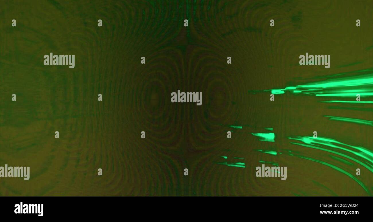 Digital image of green light trails flickering against black background ...