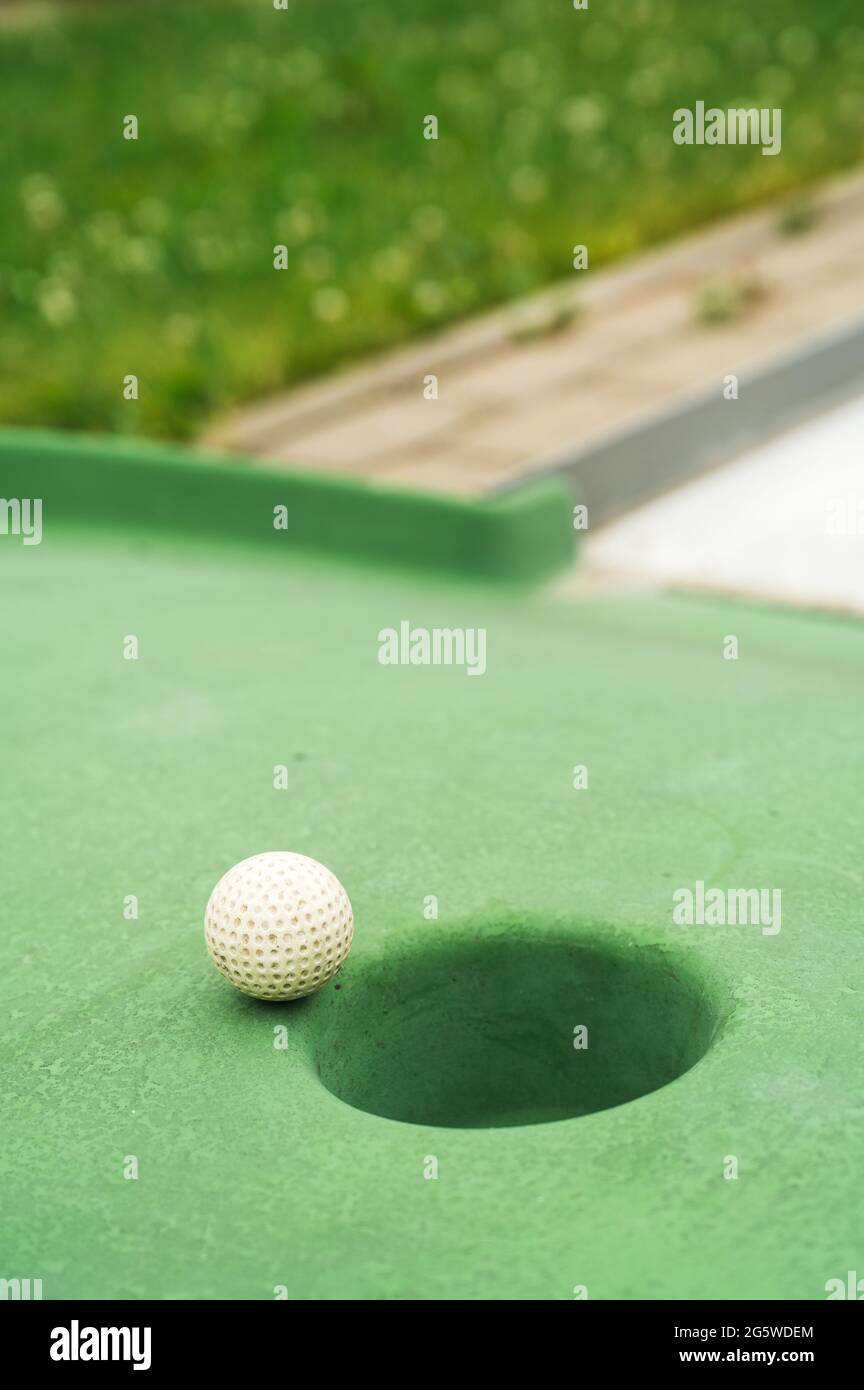 Mini golf. White ball near hole on green court. Summer outdoor game Stock  Photo - Alamy