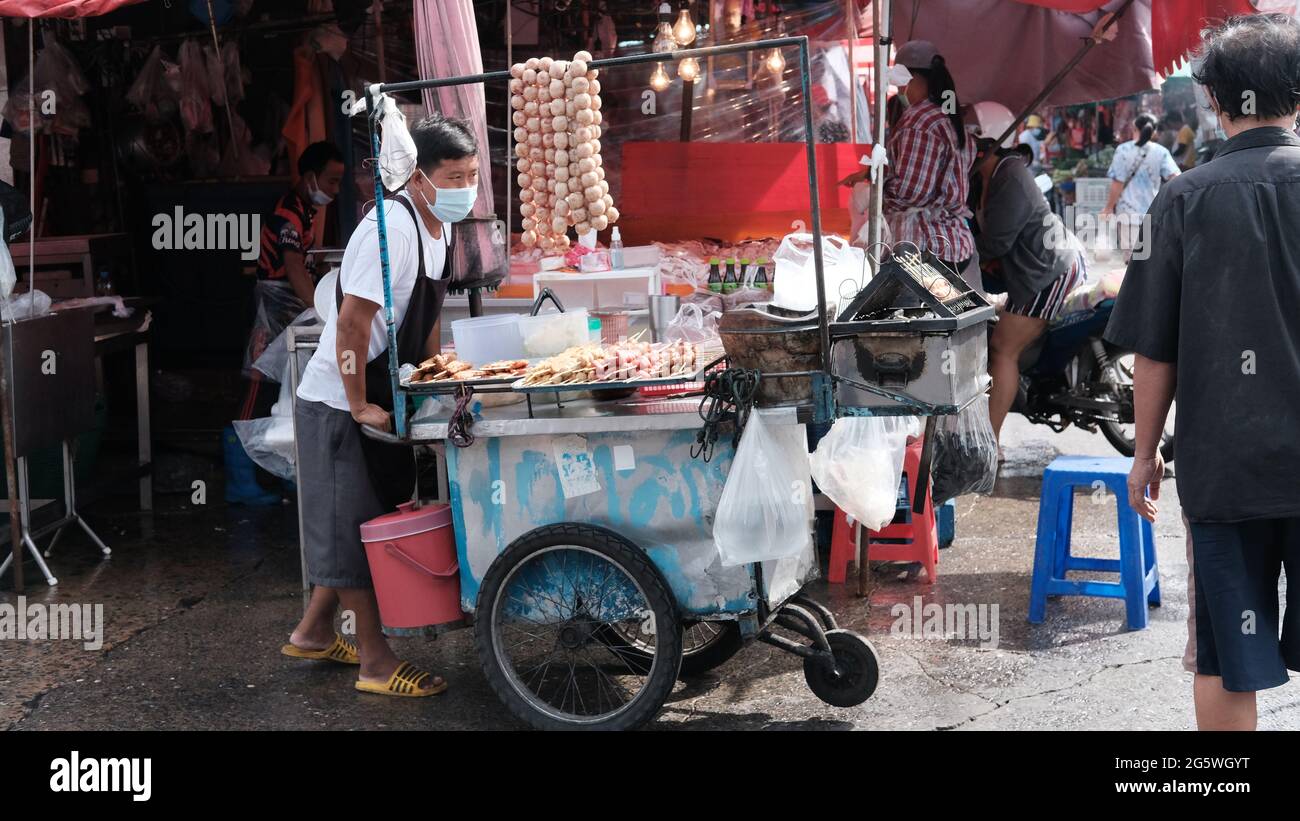 Klong Toey Market Wholesale Wet Market Bangkok Thailand largest food distribution center in Southeast Asia  Man with push cart Stock Photo