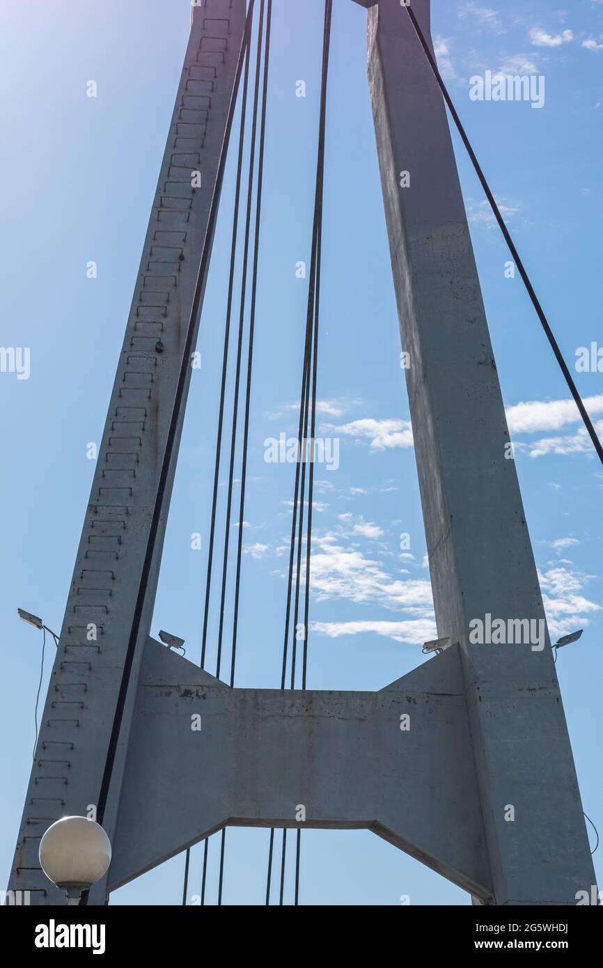 Support cable-stayed bridge with cables on the background of a blue sky ...