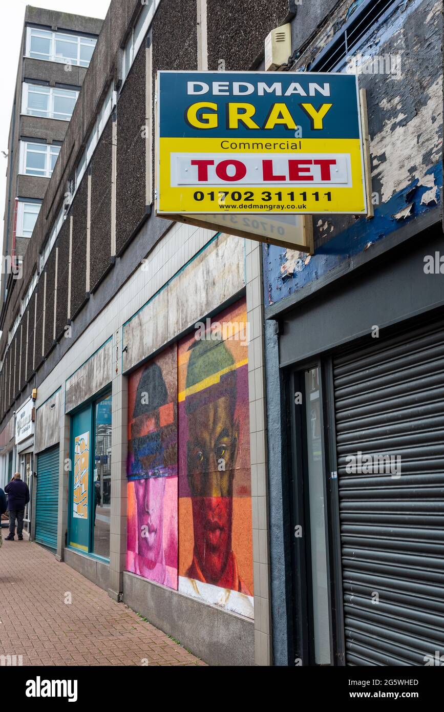 Closed and boarded up shops in the High Street in Southend on Sea, Essex, UK, with commercial property to let sign and Marcus Rashford graffiti art Stock Photo
