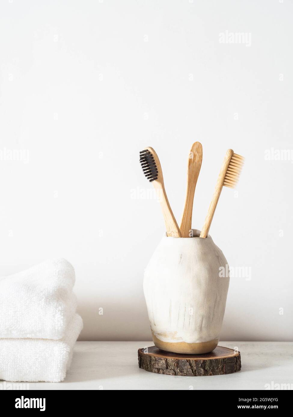 Set of wooden bamboo toothbrushes in ceramic glass. Front view Stock ...