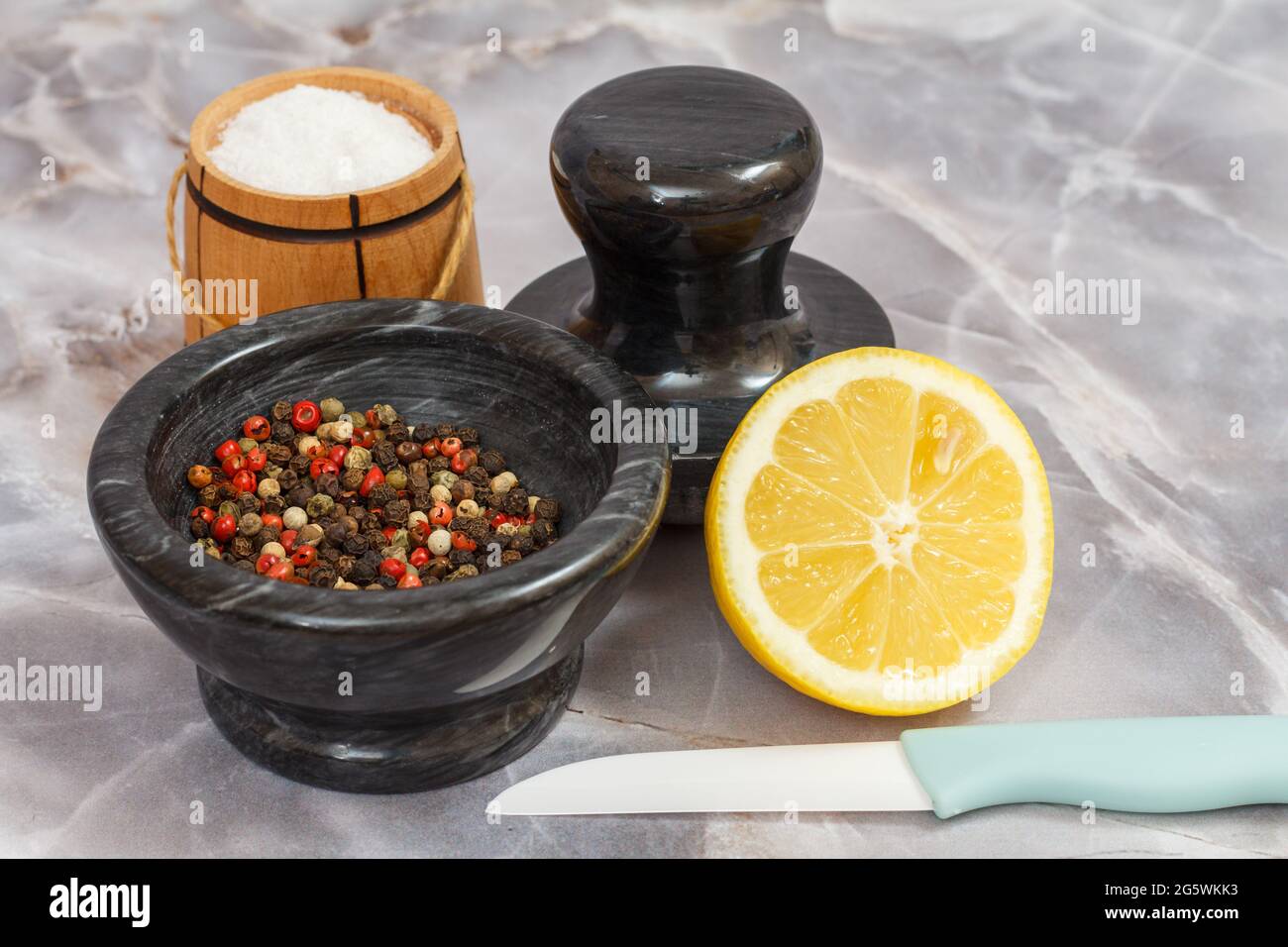 Ground salt and pepper shakers on a polished wood surface with light from a  window illuminating the table; rustic dining table with glass shakers Stock  Photo - Alamy