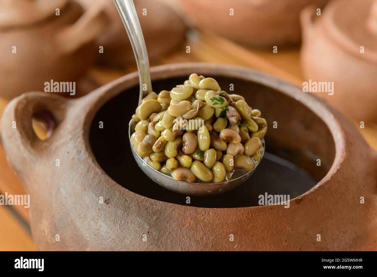 Green beans with blurred clay pots in the background. Traditional cuisine from northeastern Brazil. Stock Photo