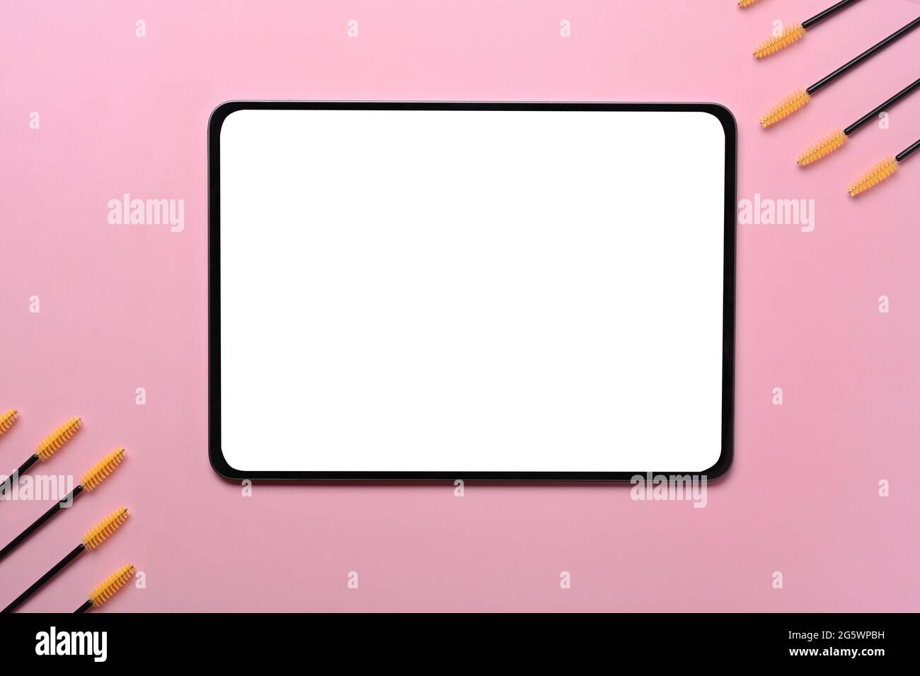 Mock up digital tablet with brush for eyelashes and eyebrows on pink pastel  background Stock Photo - Alamy