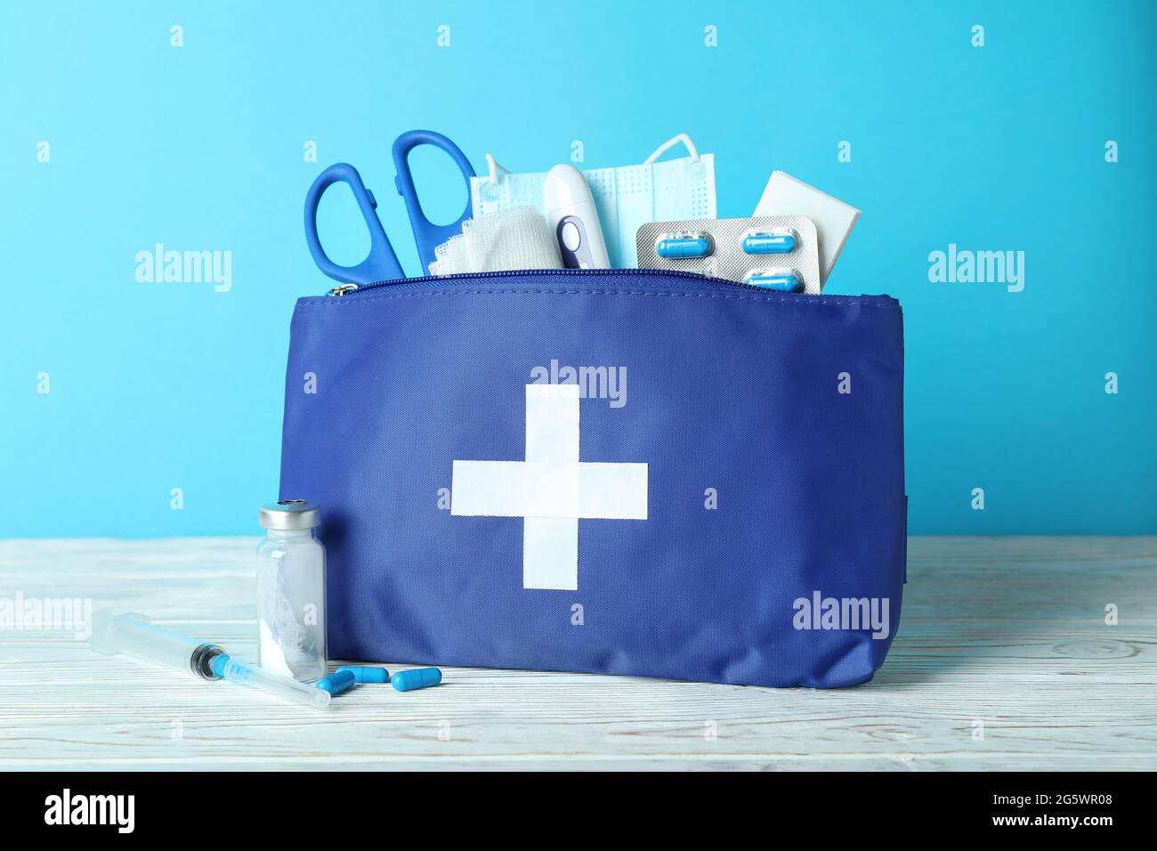 First aid medical kit against blue background Stock Photo - Alamy