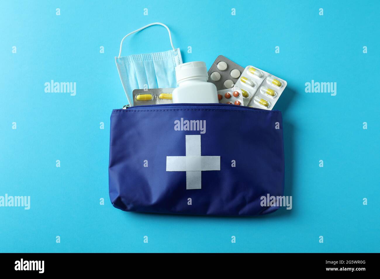 First aid medical kit on blue background Stock Photo - Alamy