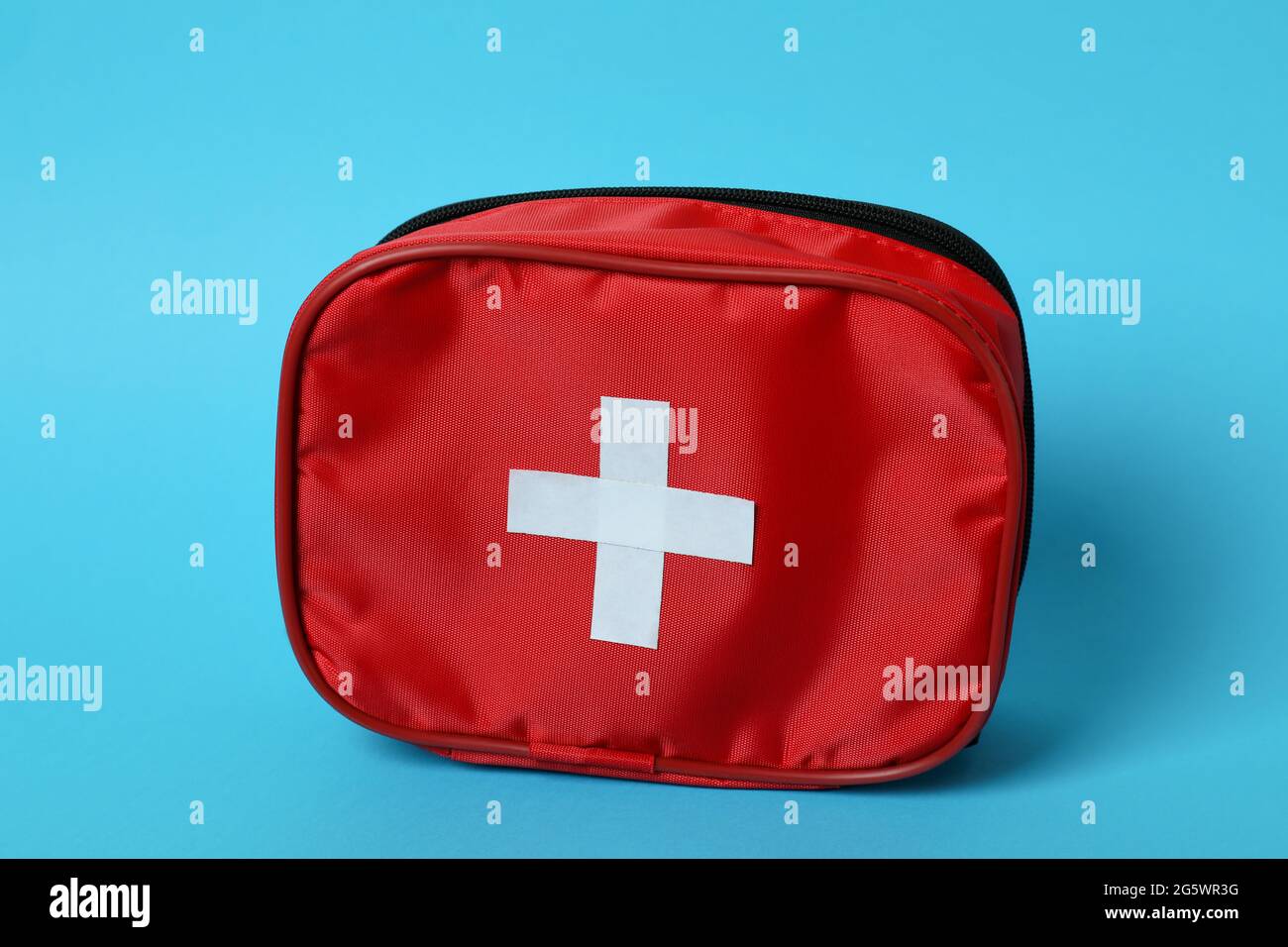 First aid medical kit on blue background Stock Photo - Alamy