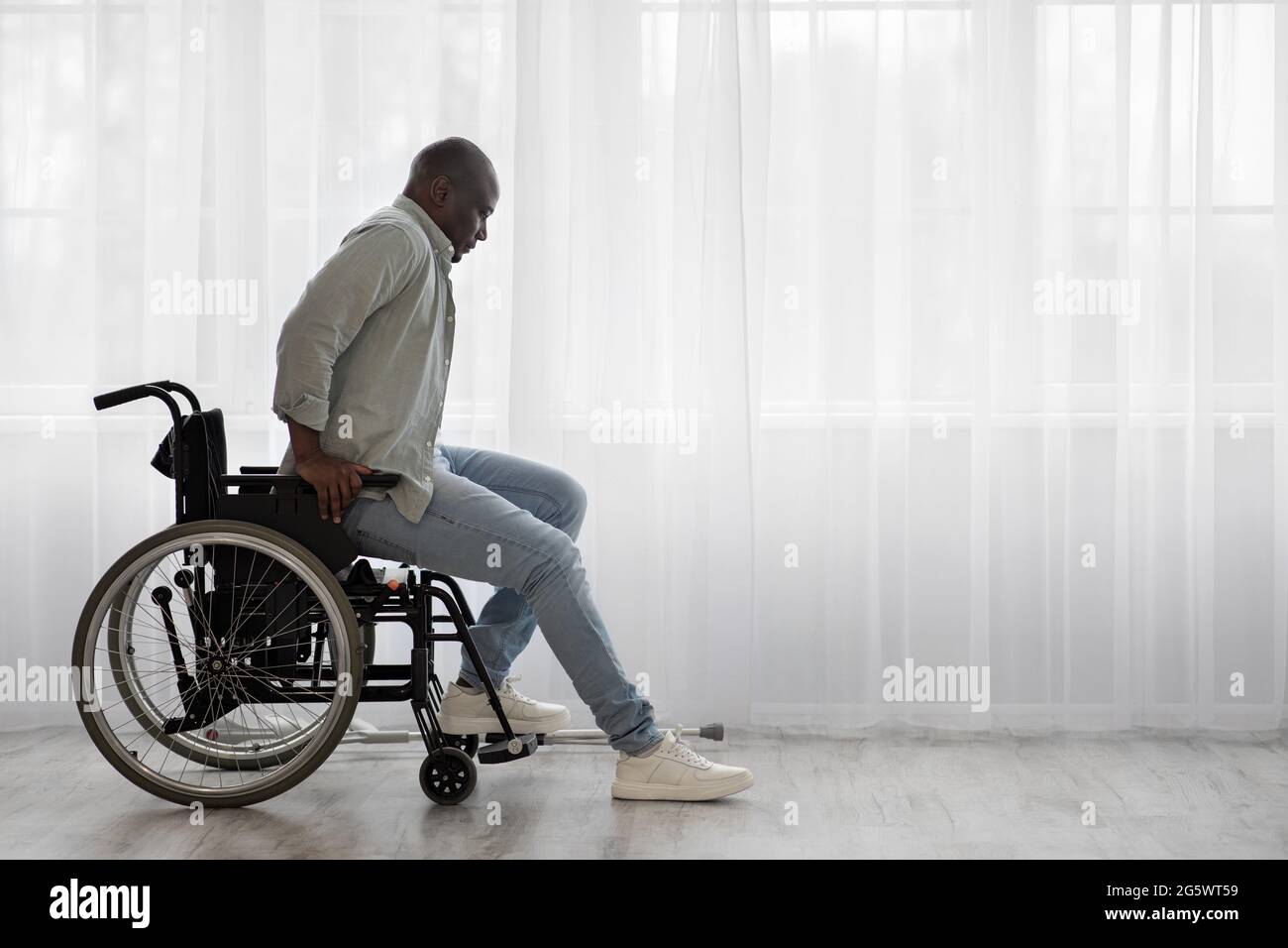 Concentrate tense mature african american man disabled stands up from wheelchair Stock Photo Alamy