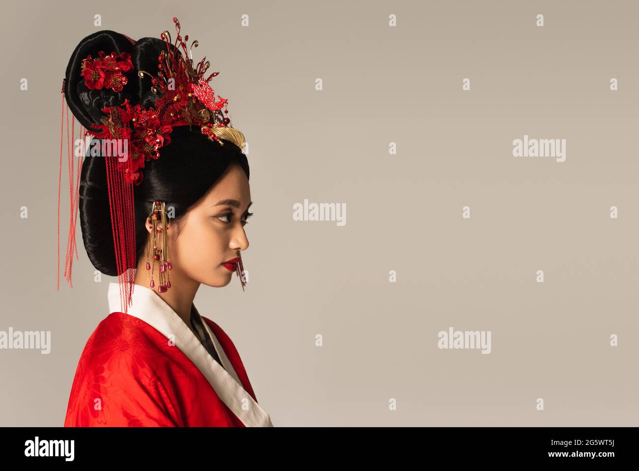 Side view of japanese woman with traditional hairdo isolated on grey