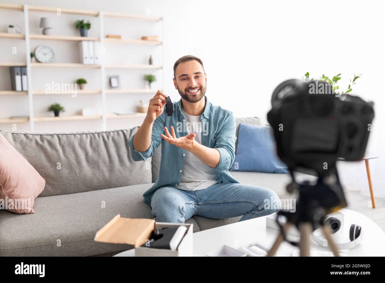 Young male influencer recording video content at home, making review on new  smartwatch model Stock Photo - Alamy